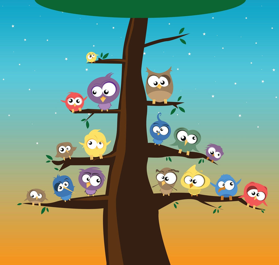 A cozy nursery features a white crib, peach curtains, and a large Birds on Tree Branches Wall Mural. A wicker light, round mirror, and basket of toys add warmth to the bright and welcoming room.