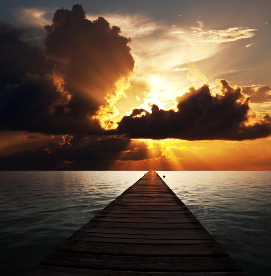 A modern open-plan living and dining area features wood floors, teal armchairs, a wooden table, and the Boardwalk on the Beach Wall Mural. The kitchen with striking yellow cabinets is visible in the background.