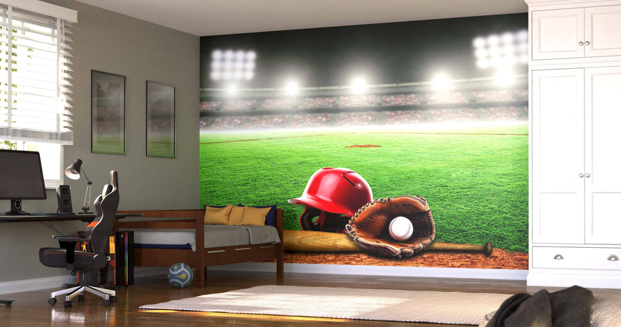 A bedroom with a desk, bed, white wardrobe, window, and framed pictures features the "Baseball Equipment on the Field Wall Mural," showcasing a striking display of a red helmet, bat, mitt, and baseball under stadium lights.