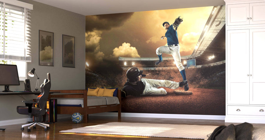 A bedroom features the Baseball Players in Action Wall Mural, showing a baseman trying to tag out a sliding runner at a crowded stadium. The decor includes a bed, desk with computer, chair, window blinds, soccer ball, and framed pictures.