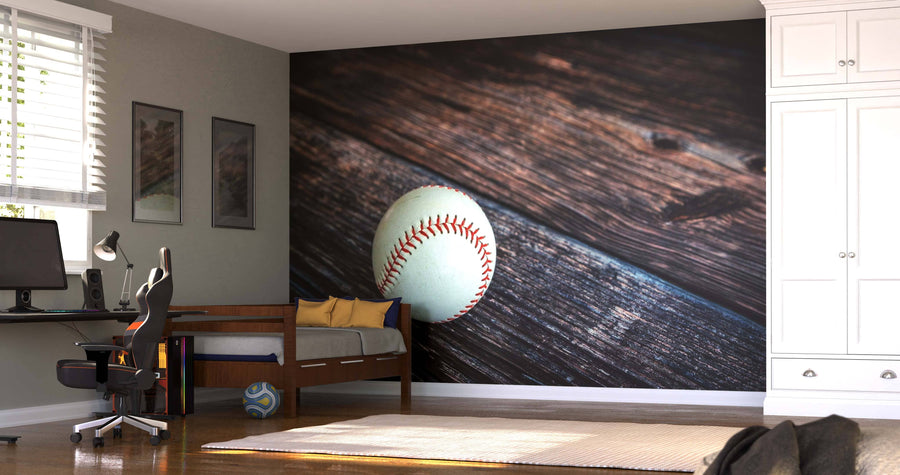 A bedroom featuring a Baseball on Wooden Table Wall Mural (peel and stick), blue daybed, computer desk with swivel chair, window blinds, patterned ball on the floor, and white built-in closets—easy to install.
