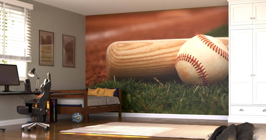A bedroom showcases the Game Day Ready Wall Mural, displaying a close-up of a baseball and bat on grass. The room also features a desk with computer, chair, daybed with blue and yellow pillows, pictures, soccer ball, and white built-in closets.