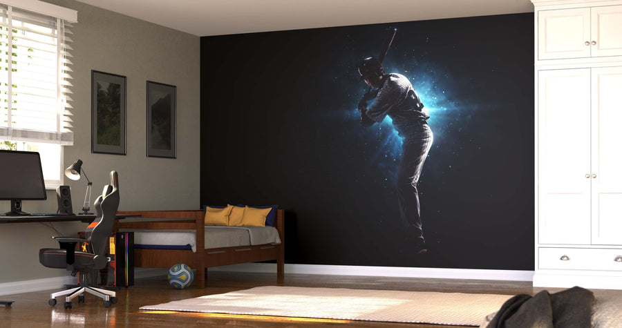 A modern bedroom showcases the Midnight Swing Wall Mural, depicting a baseball player swinging a bat against a glowing blue background. The space includes a desk with computer, yellow and blue pillows, framed art, white wardrobe, and sunlit window.