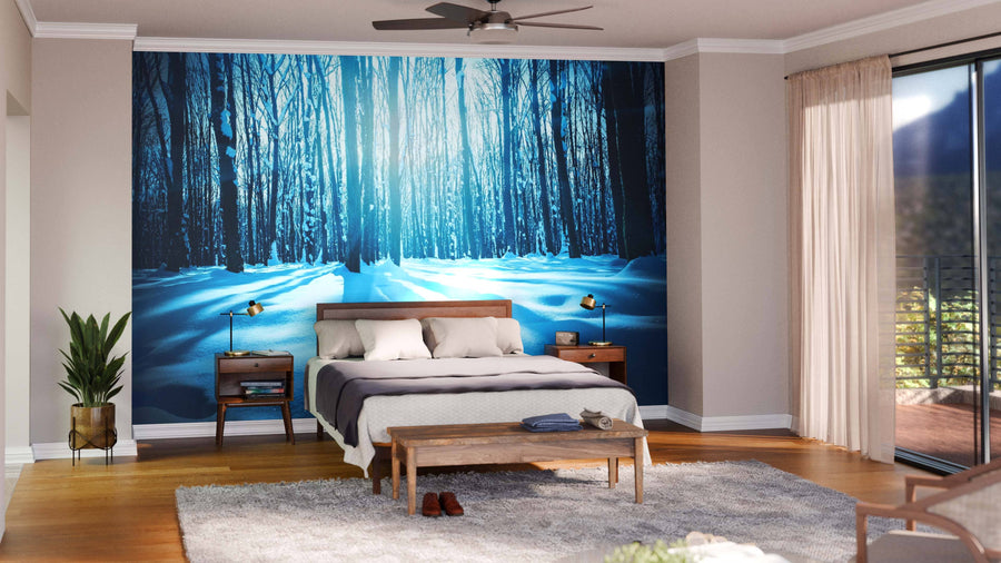 Modern living-dining space with wood floors, teal and brown furniture, rugs, and pendant lights. The Forest Trees Nature Snow Wood Wall Mural adds depth and a cool vibe to the warm-toned room with its snowy forest and blue sunlight design.