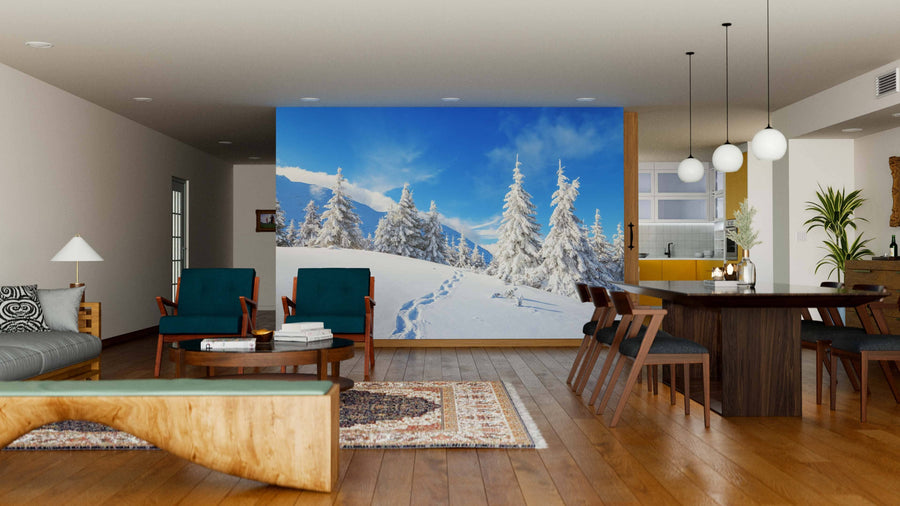 A modern living-dining room with wood floors and mid-century furniture is highlighted by the Beautiful Winter Landscape Wall Mural. Soft lighting creates ambiance, and the kitchen appears in the background.
