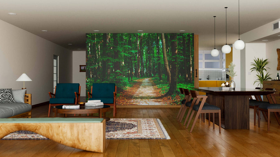 A modern open-concept living and dining area with wood floors, contemporary furniture, and a Dark Green Forest Wall Mural as a nature-inspired focal point. Pendant lights hang above a dark wooden dining table set for six.