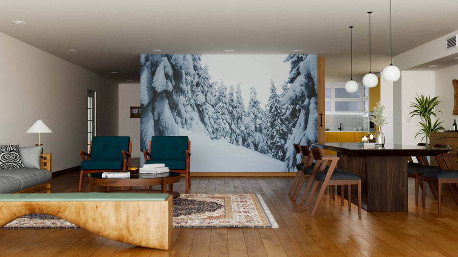 Modern living and dining room with wooden floors, mid-century furniture, and the Krivan Mountains in High Tatras Wall Mural. Cozy rugs, plants, and hanging lights add style, while the peel-and-stick removable mural brings scenic charm to the space.