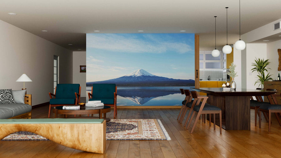 Modern living and dining room with wooden floors, mid-century furniture, rugs, and a large Reflections of Mt Fuji Wall Mural. Pendant lights hang over the dark dining table; kitchen is visible. The space feels bright and open.