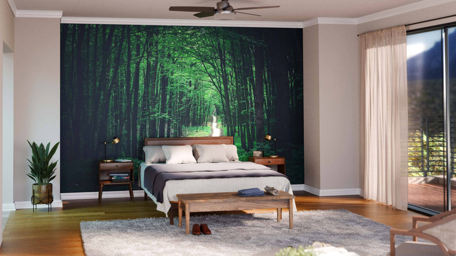 Modern open living-dining space with wood floors, gray sofa, blue chairs, round coffee tables, dining set, pendant lights, and kitchen. A Long Pathway in Green Forest Wall Mural adds nature-inspired style to the room.