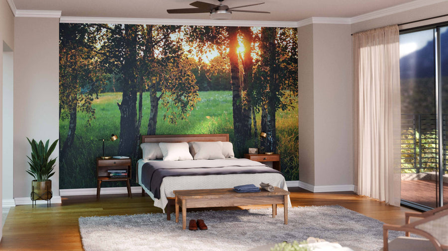 A modern open-plan living and dining room with wood floors, stylish furniture, and a striking Meadow with High Grass Wall Mural. Pendant lights hang over a dark wood table; yellow kitchen cabinets are visible in the background.