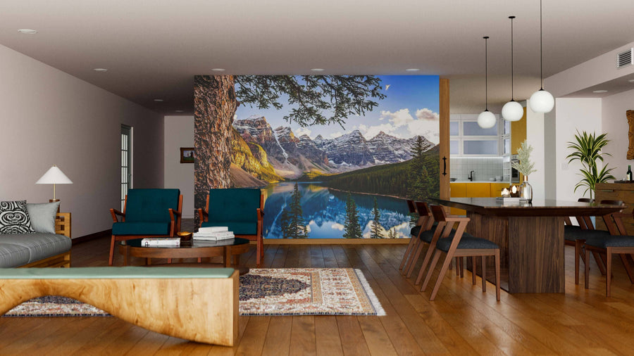 A modern living and dining room with wood floors, teal chairs, a beige sofa, and the Moraine Lake and Mountain Range Wall Mural brings vibrant mountain and lake scenery into this stylish, contemporary space.
