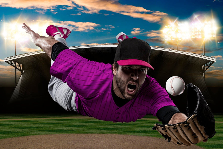 A bedroom showcases a Professional Baseball Player Wall Mural, depicting a player diving for a catch. The room also contains a desk with computer, chair, bed, soccer ball, wardrobe, and is lit by daylight through white-blinded windows.