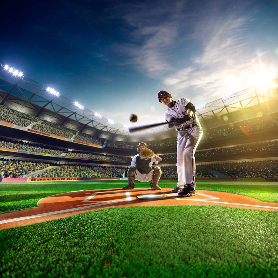 A bedroom with a desk, computer, and bed features the Baseball Players on Grand Field Wall Mural showing a dramatic baseball scene under stadium lights. Sunlight streams in, and a soccer ball rests on the floor near the bed.