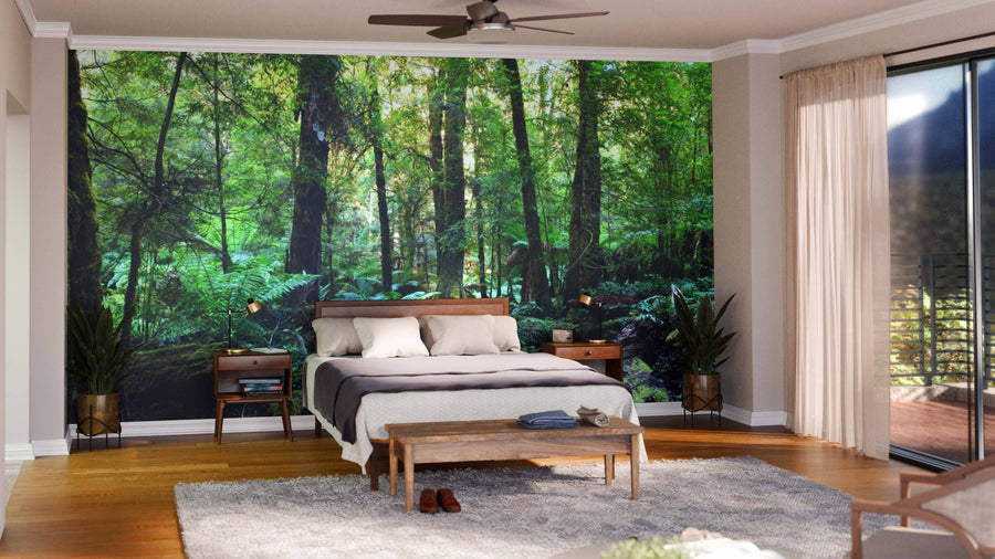 Modern open-plan living and dining room with wooden floors, eclectic furniture, and the Rainforest Panorama Wall Mural for a tranquil vibe. Stylish pendant lights and patterned rugs complete the look.
