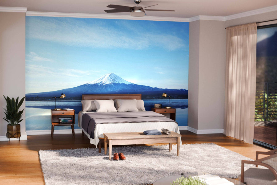 Modern living and dining room with wooden floors, mid-century furniture, rugs, and a large Reflections of Mt Fuji Wall Mural. Pendant lights hang over the dark dining table; kitchen is visible. The space feels bright and open.