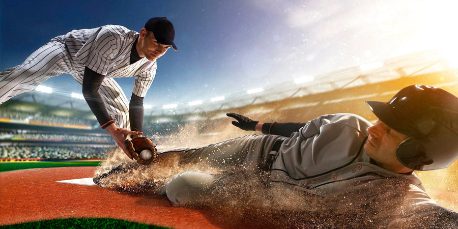 A bedroom showcases the Sliding Into Victory Wall Mural depicting a dramatic baseball scene. The space also features a desk, chair, bed, framed art, and sunlight shining through blinds onto a wooden floor.