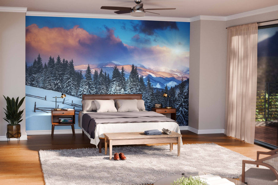 A modern open living-dining area features wood floors, mid-century furniture, and the “Snowy Rolling Hills Wall Mural,” which brings color and warmth to the neutral decor. Spherical pendant lights are suspended above the dining table.
