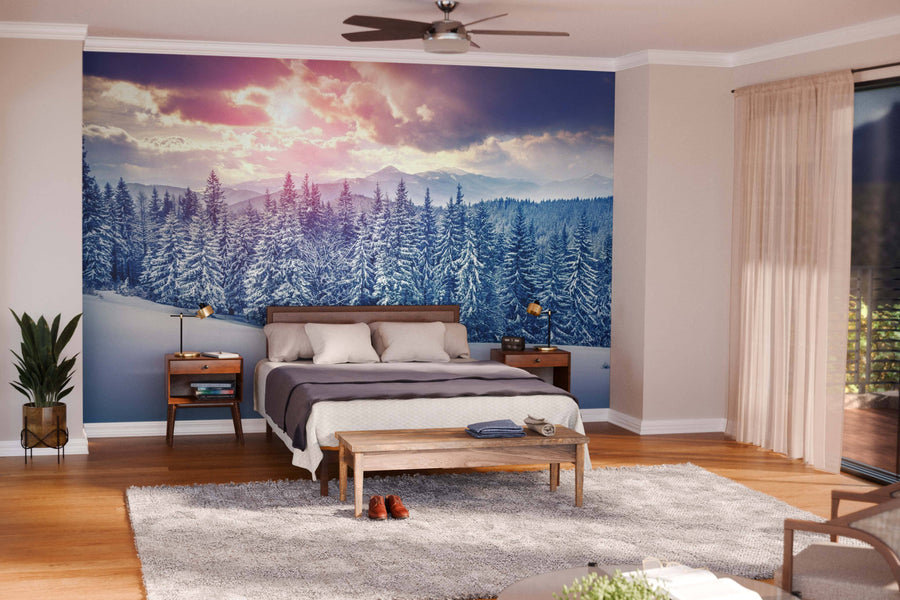 Modern open-plan living and dining room with wood floors, green armchairs, abundant natural light, a pendant-lit dining table, kitchen in the background, and a Sunrise in the Carpathian Mountains Wall Mural creating a stunning focal point.