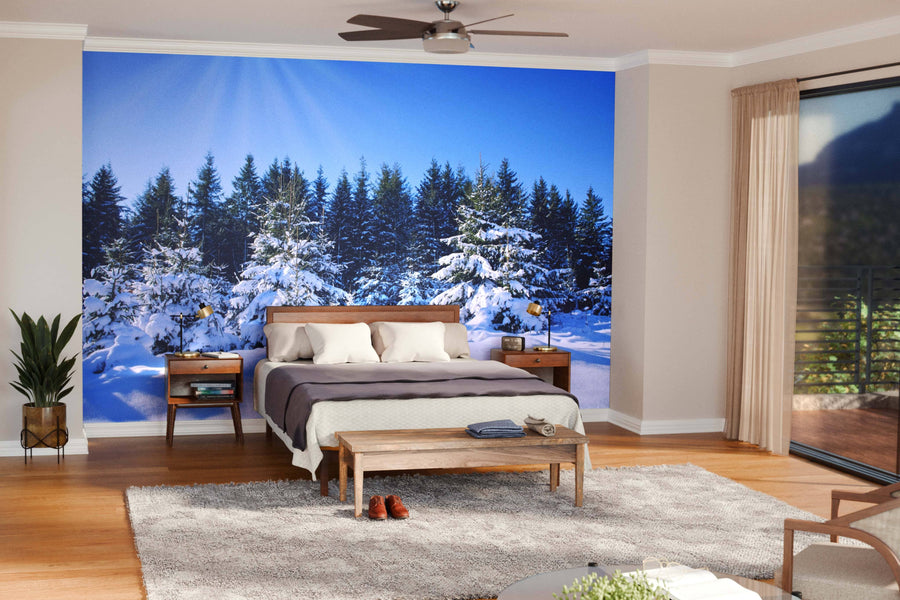 A modern living-dining area with wood floors, stylish furniture, and globe pendant lights features the Sunset in the Winter Forest Wall Mural, adding charm and a wintry landscape to this open, cozy space filled with natural and artificial light.