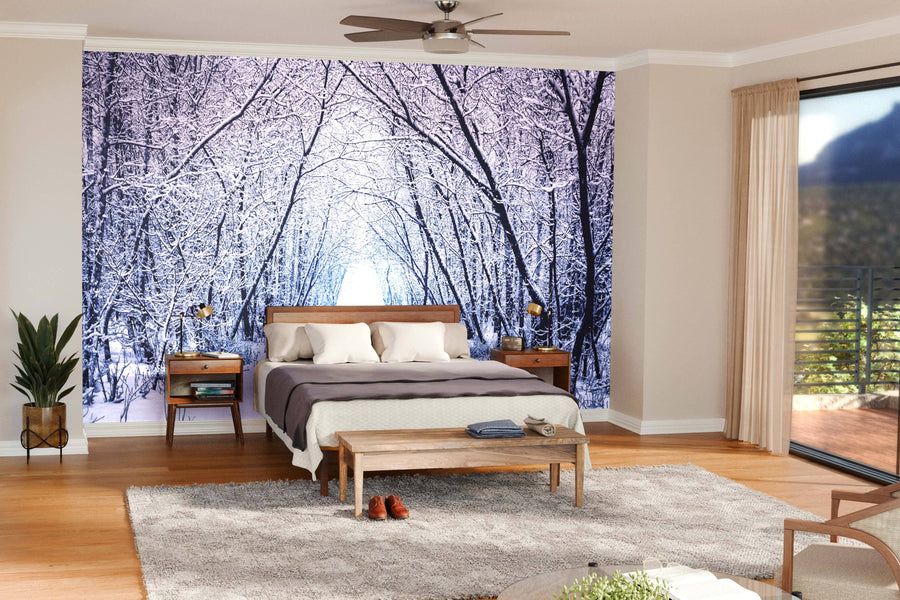 A spacious living and dining area features wood floors, dark teal chairs, a large dining table, and the Winter Forest Alley with Trees Wall Mural. Modern lighting, cozy furnishings, decor, and indoor plants complete the inviting space.