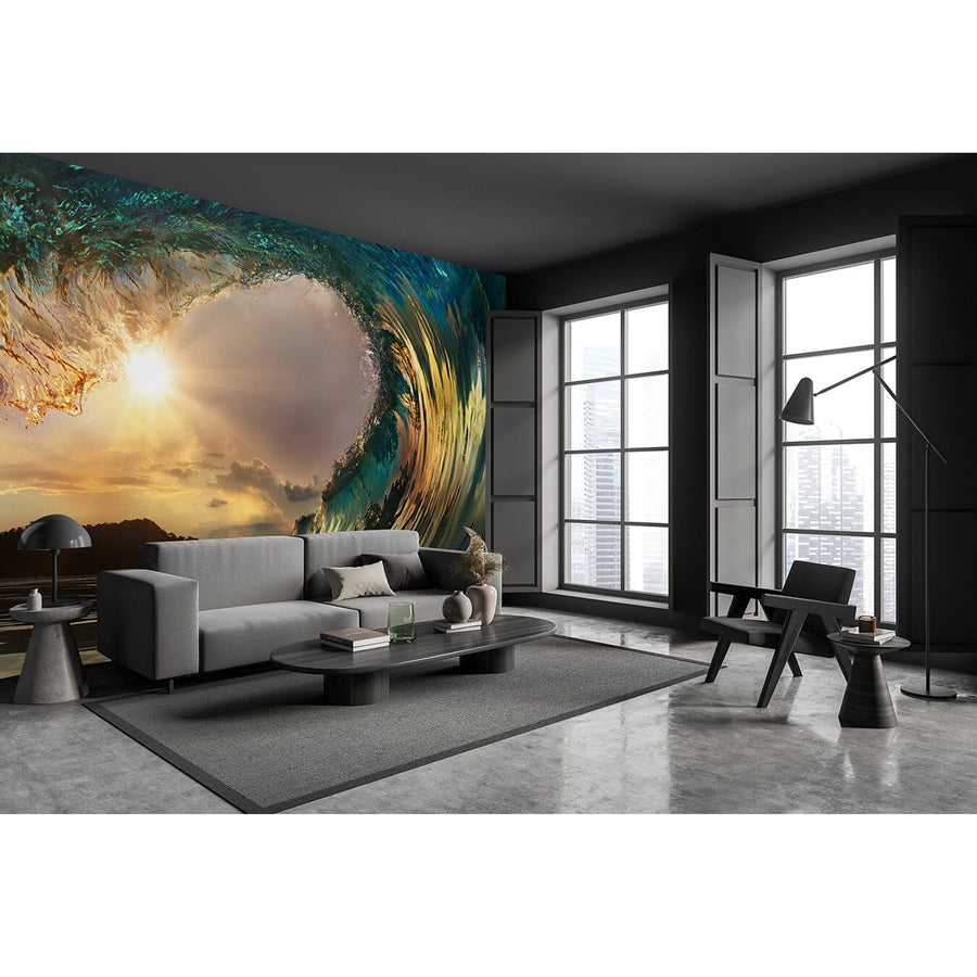 A modern bedroom showcases the Breaking Point Wall Mural, depicting a sunlit wave curl. The space includes a bed, desk with computer, chair, striped pillows, white wardrobe, and sunlight filtering through window blinds.