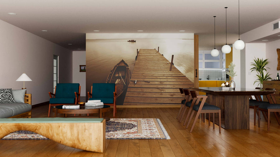 A stylish living and dining room with wooden floors, modern furniture, warm lighting, and the Albufera Lake Wetlands Pier Wall Mural featuring a dock and boat scene. The space includes armchairs, sofa, rug, dining set, and potted plants.