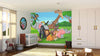A bright nursery with wooden floors and white furniture features the All Together Wild Wall Mural of cartoon jungle animals. Playful touches like toys, a crib, and a rocking horse complete this cheerful space with stylish, removable wallpaper accents.