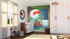 A nursery with a crib, stuffed giraffe, and toy horse features the Animals on a Boat Wall Mural—a colorful peel and stick design of cartoon animals sailing at night under the moon, framed by trees. Warm natural light brightens the space.