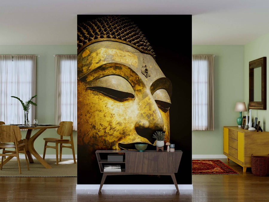 A living room with pale green walls features the Antique Bronze Buddha Wall Mural as a stunning focal point. Mid-century modern furniture, a wooden sideboard, dining table, and decorative plants complete this serene space.