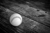 Black and white baseball on weathered wooden surface – Peel and Stick Wall Murals