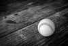 Monochrome baseball with red stitching on rustic wood – Peel and Stick Wall Murals