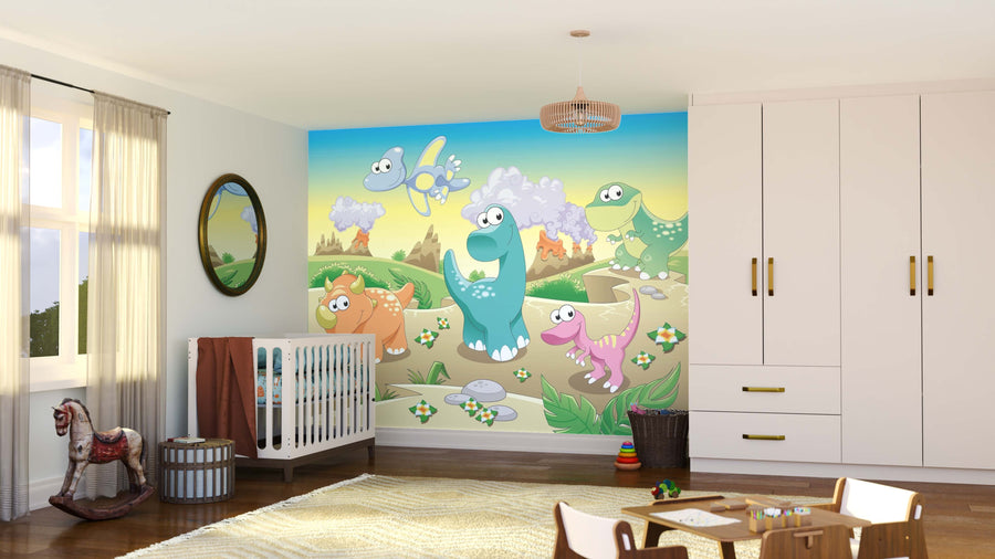 A nursery with a crib, white wardrobe, mirror, rocking horse, and basket features the Baby Dinos Wall Mural—smiling cartoon dinosaurs and birds in a whimsical prehistoric scene under a bright sky. Sunlight pours through the window.