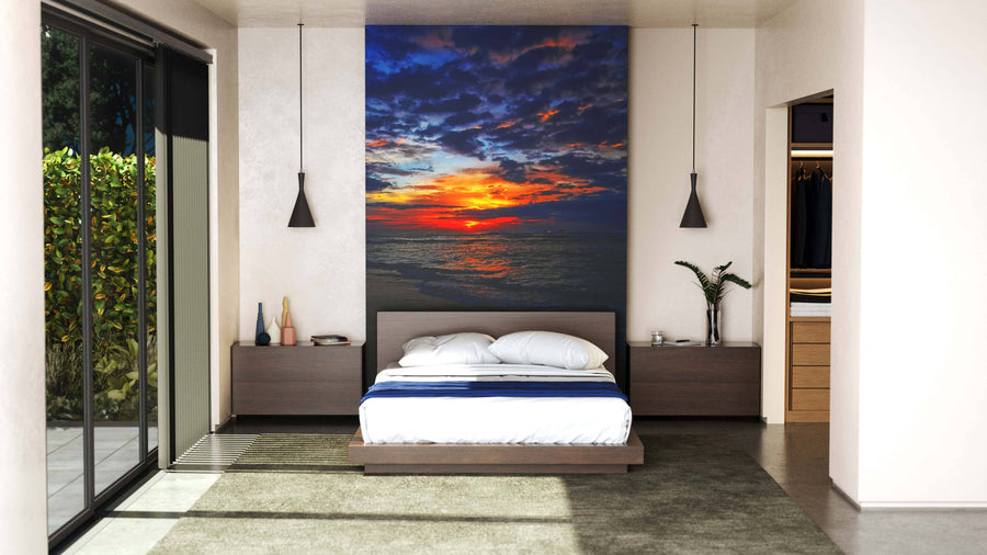 A modern bedroom features a low bed between two nightstands and pendant lights. Above the bed, the Bali Landscape Wall Mural adds vibrant color. Glass doors reveal greenery, while a walk-in closet is on the right.
