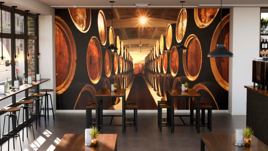 Modern restaurant interior with wooden tables, plants, and large windows features a striking Barrels of Wine Wall Mural, adding a warm and inviting atmosphere with its custom printed design.