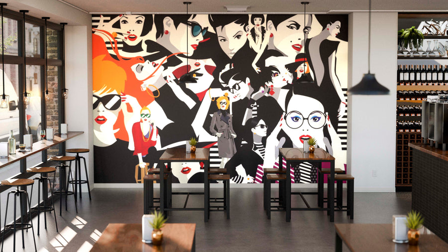 A modern café interior with wooden tables, stools, wine racks, and a large Uptown Chic Wall Mural on the back wall featuring stylish illustrations of fashionable women in bold colors with orange accents.