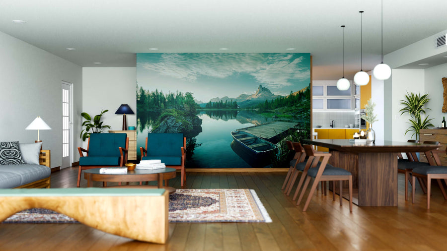 Modern open-concept living and dining room with wooden floors, contemporary furniture, and the "Beautiful Lake at Dawn Wall Mural." The space features plants, pendant lights, and blue, green, and natural wood accents.