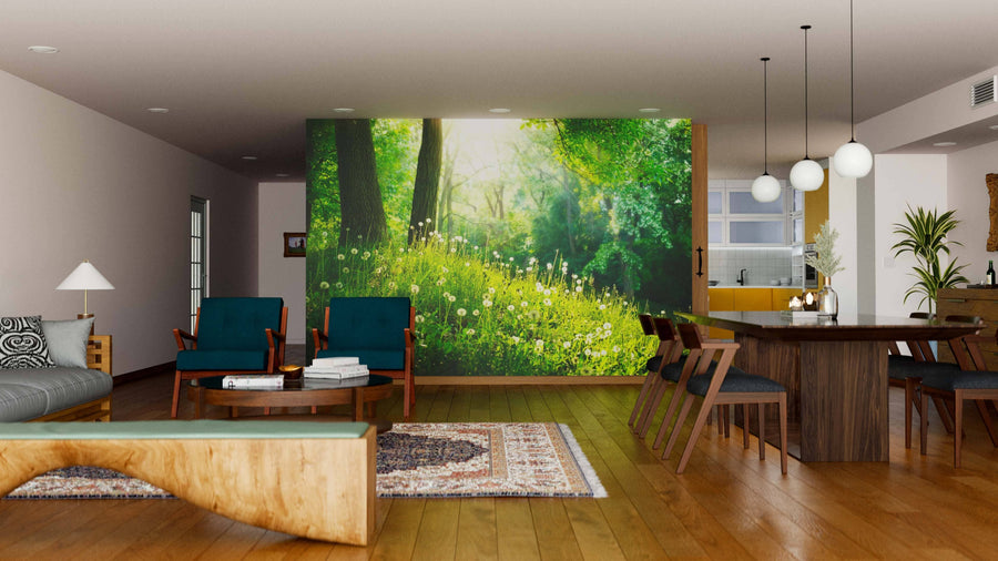 Modern open-plan living and dining room with wooden floors, teal armchairs, a gray sofa, globe lights, cozy rugs, and the Beautiful Landscape Wall Mural as a sunlit forest scene centerpiece. Warm decor completes the inviting space.