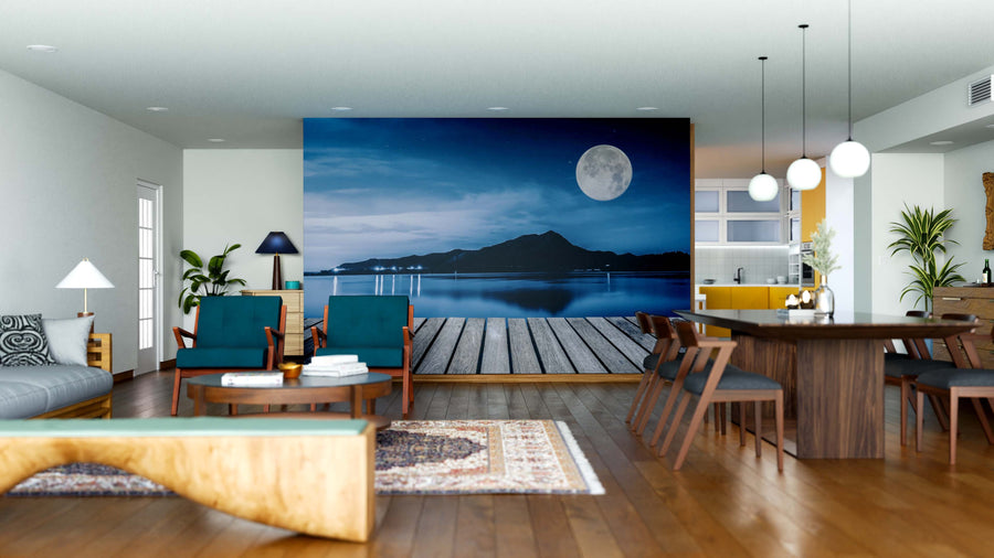 A modern open-plan living and dining area features wooden floors, contemporary furniture, and the Boardwalk and Lake Wall Mural—a striking peel and stick design—paired with pendant lights, rugs, and cozy accents for a complete look.