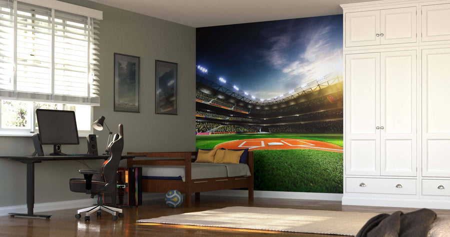 A modern bedroom features a desk, computer, swivel chair, single bed with pillows, and white wardrobe. Behind the bed is the Baseball Grand Arena in Sunlight Wall Mural, its vibrant stadium scene energizing the space.