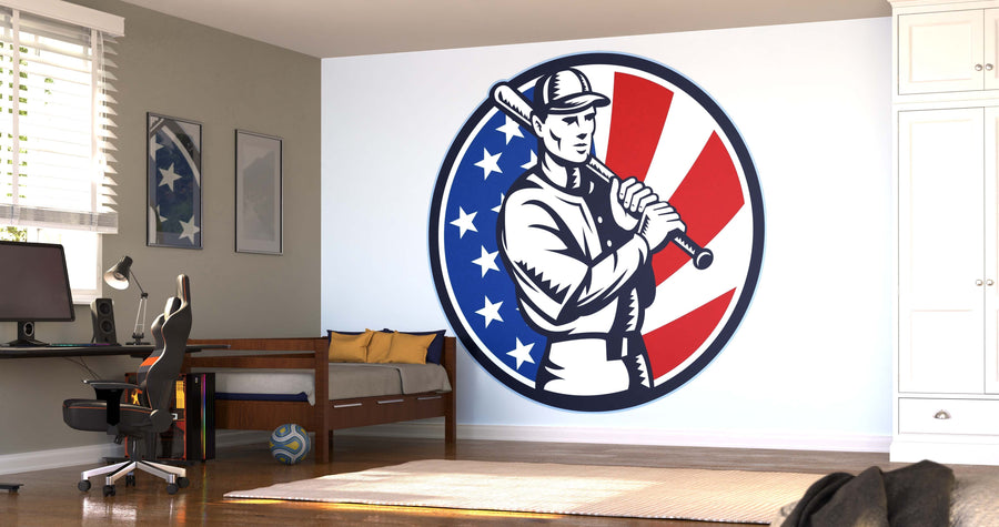 A modern bedroom showcases the Baseball Icon Wall Mural, a large matte canvas textured removable mural of a vintage baseball player with stars and stripes. The space features a desk, chair, bed, white closet, and sunlight streaming through the window.