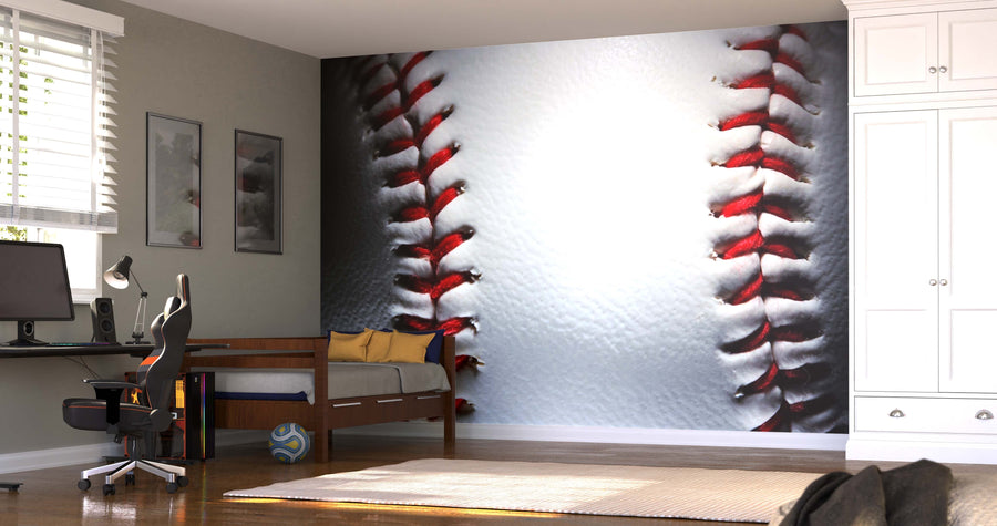 A modern bedroom features the Closeup of a New Baseball Wall Mural with red stitches, a wooden daybed with yellow pillows, a computer desk, and closet. Sunlight filters through blinds as a ball rests on the wooden floor.