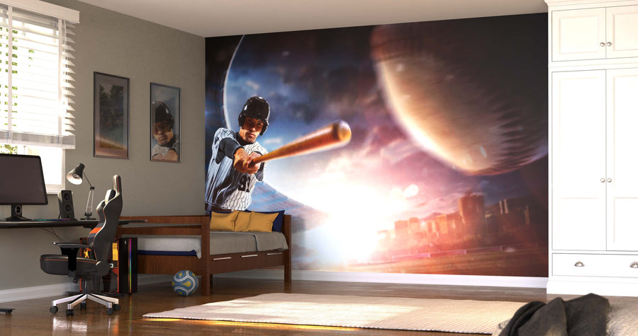 A bedroom displays the Game-Changing Hit Wall Mural, showing a baseball player swinging amid planets. On the left are a bed, computer desk, and chair; posters and a soccer ball add décor. A white wardrobe stands on the right.