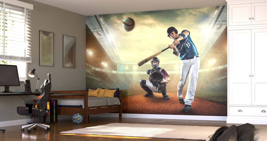 A modern bedroom showcases the Power Hit Wall Mural, depicting a batter swinging in a stadium. The room includes a single bed, a desk with computer, and a soccer ball on the floor.