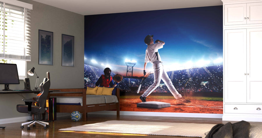 A modern bedroom showcases the Swing for the Fences Wall Mural, depicting a baseball player swinging in a bright stadium. The room has a desk, chair, daybed, and sports balls on the floor, with sunlight streaming through white shutters.