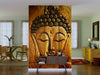A living room showcases the "Buddha Wall Mural 1" with a serene Buddha face and cracked golden texture, paired with modern wooden furniture, a dining table, yellow dresser, and greenery in soft daylight.
