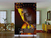 A modern living space features a dining area with wooden furniture, sheer curtains, and decor. The Buddha Zen Orchidee Statue Gott Wall Mural adds a serene touch, displaying a peaceful bronze Buddha softly lit for a calming atmosphere.