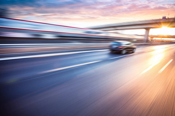 Car Driving on Freeway at Sunset Wall Mural