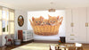 A bright nursery features a crib, toys, mirror, and the Cats in a Basket Wall Mural displaying three orange kittens in a wicker basket. Light streams through the window and a soft rug adds warmth to the wooden floor.