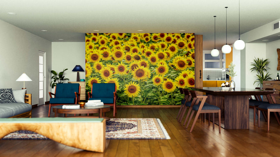 A modern open living-dining area features wood floors, contemporary furniture, rugs, and a striking Cheerful Sunflower Field Wall Mural. Pendant lights hang over a wooden dining table, with large windows that fill the space with natural light.