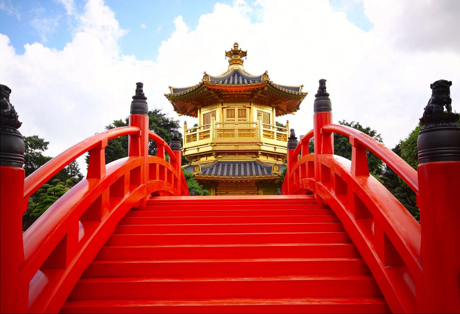 Modern open-plan living and dining space with wooden floors and furniture. The Chi Lin Nunnery Wall Mural, featuring a vivid red bridge to a traditional pavilion, adds vibrant color as the room’s stunning focal point.